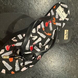 Kate Spade sassy black flip flops with lipstick graphics.  Size 7